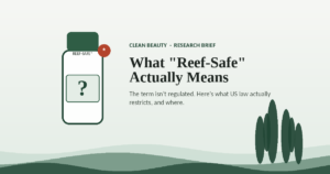 Illustration of a sunscreen bottle labeled with a question mark, representing the unregulated "reef-safe" claim on sunscreen packaging